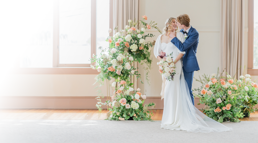 Couple beneath a floral arch